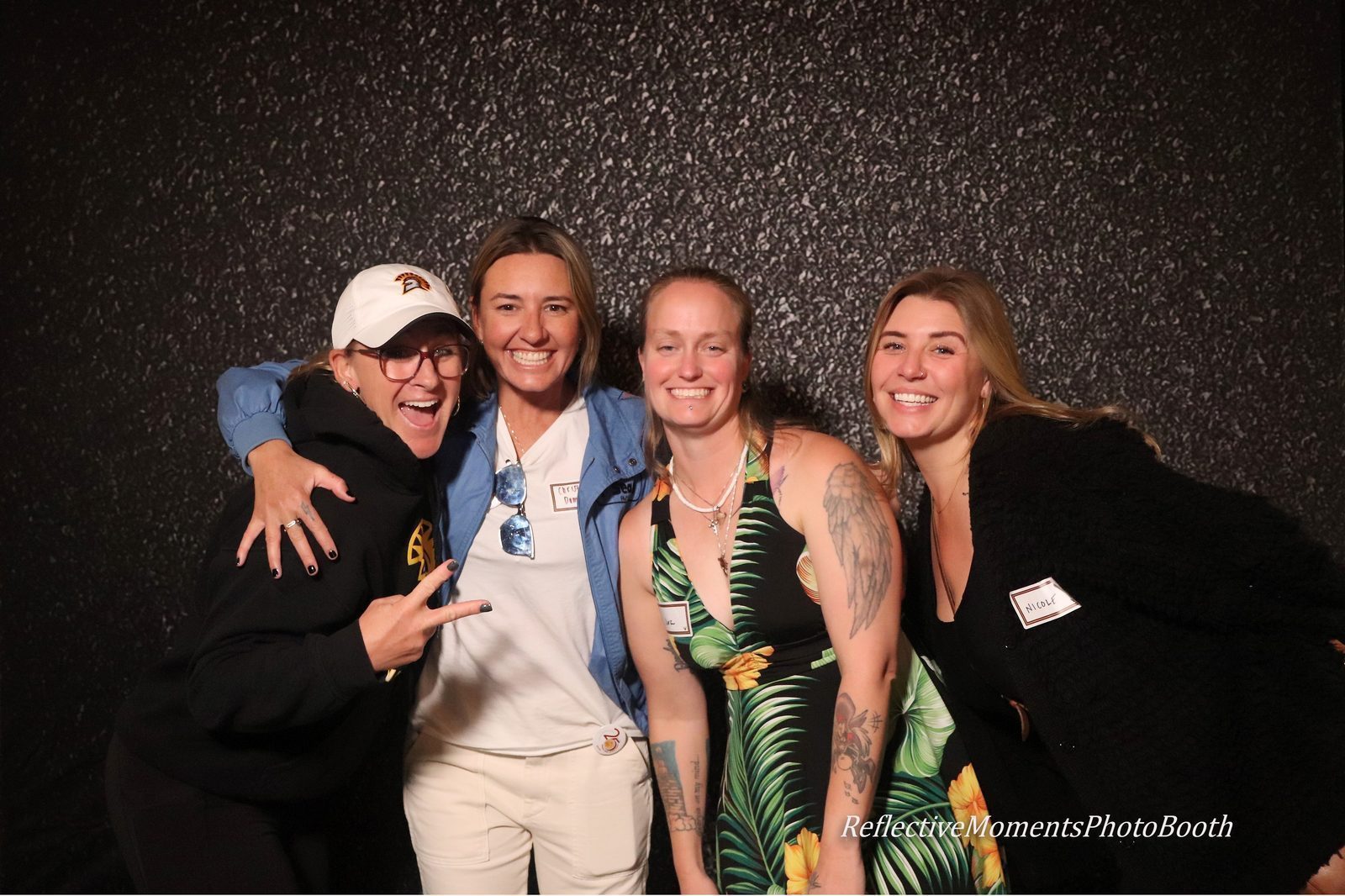 Classmates laughing together at the 20-year high school reunion photo booth