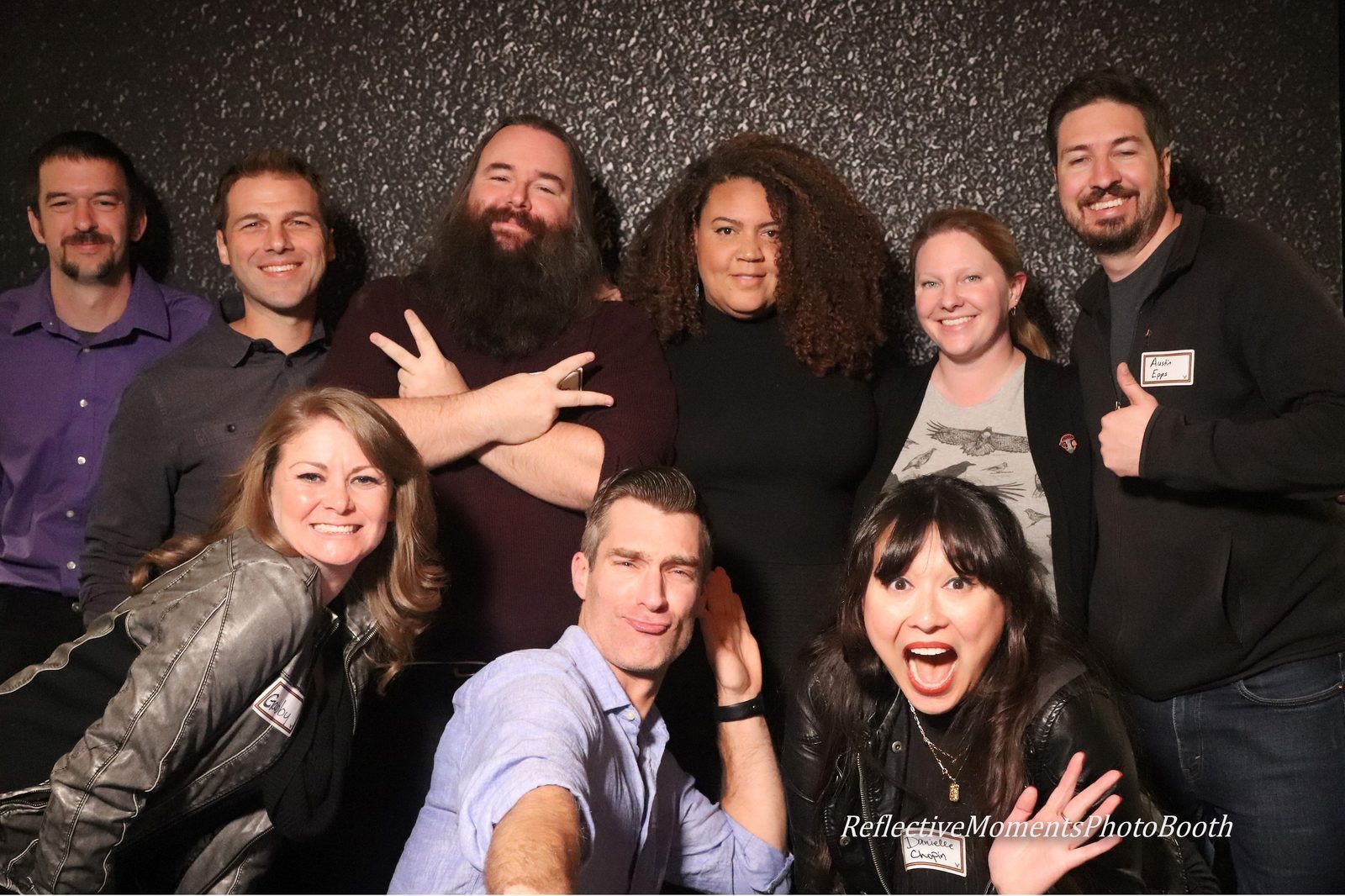 Group of alumni celebrating at the mirror booth during their high school reunion
