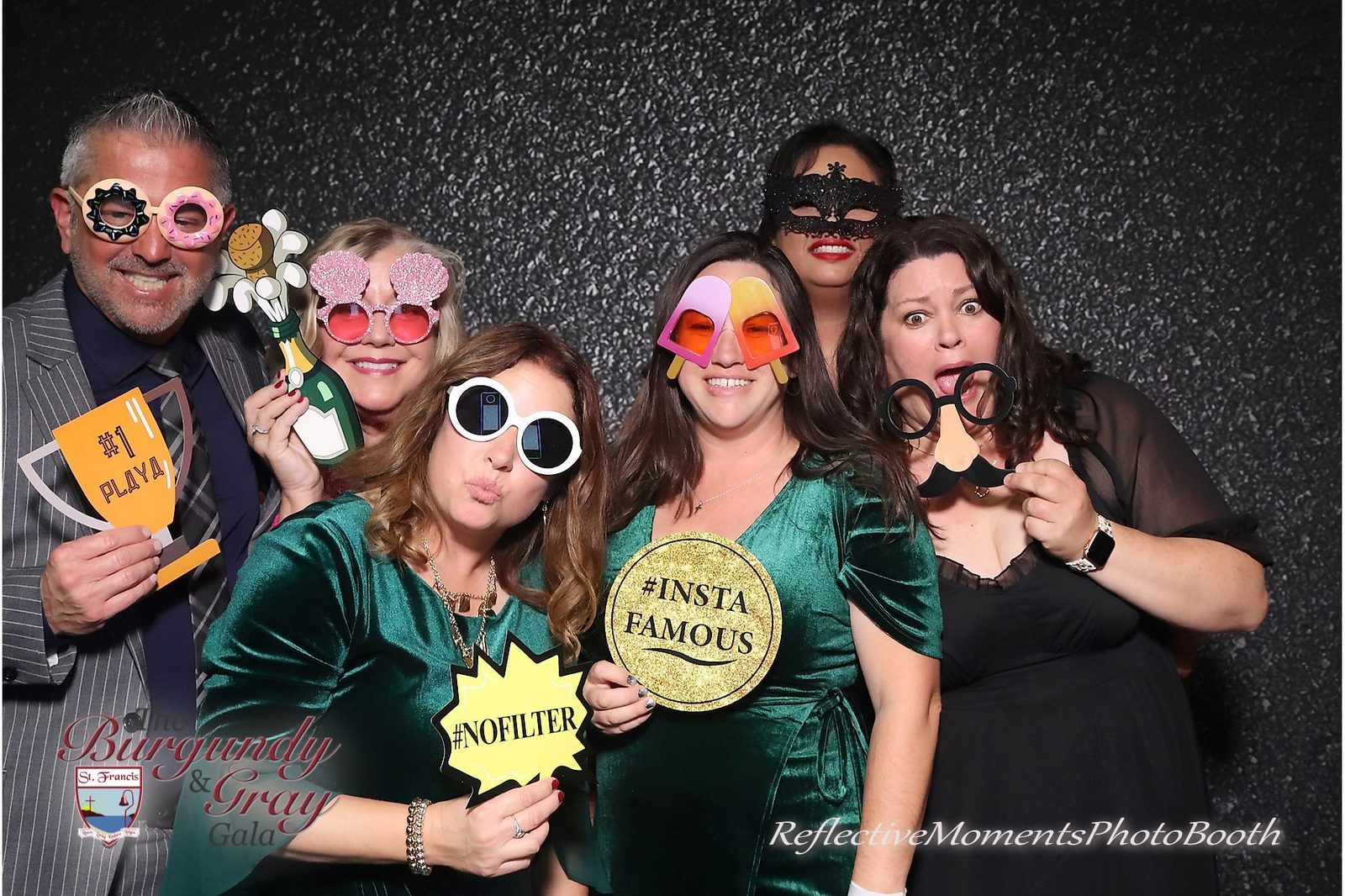 Guests enjoying the mirror photo booth at the Burgundy and Grey Gala