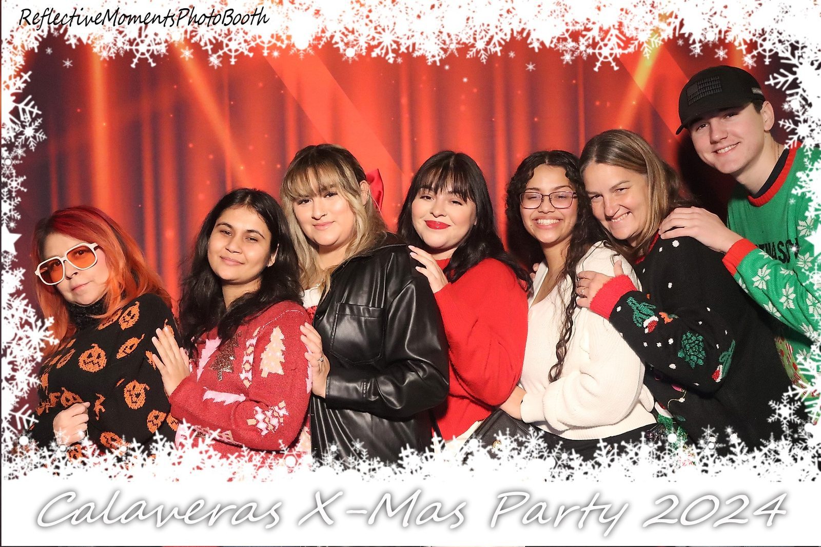 Guests in festive holiday attire at the Christmas party mirror photo booth