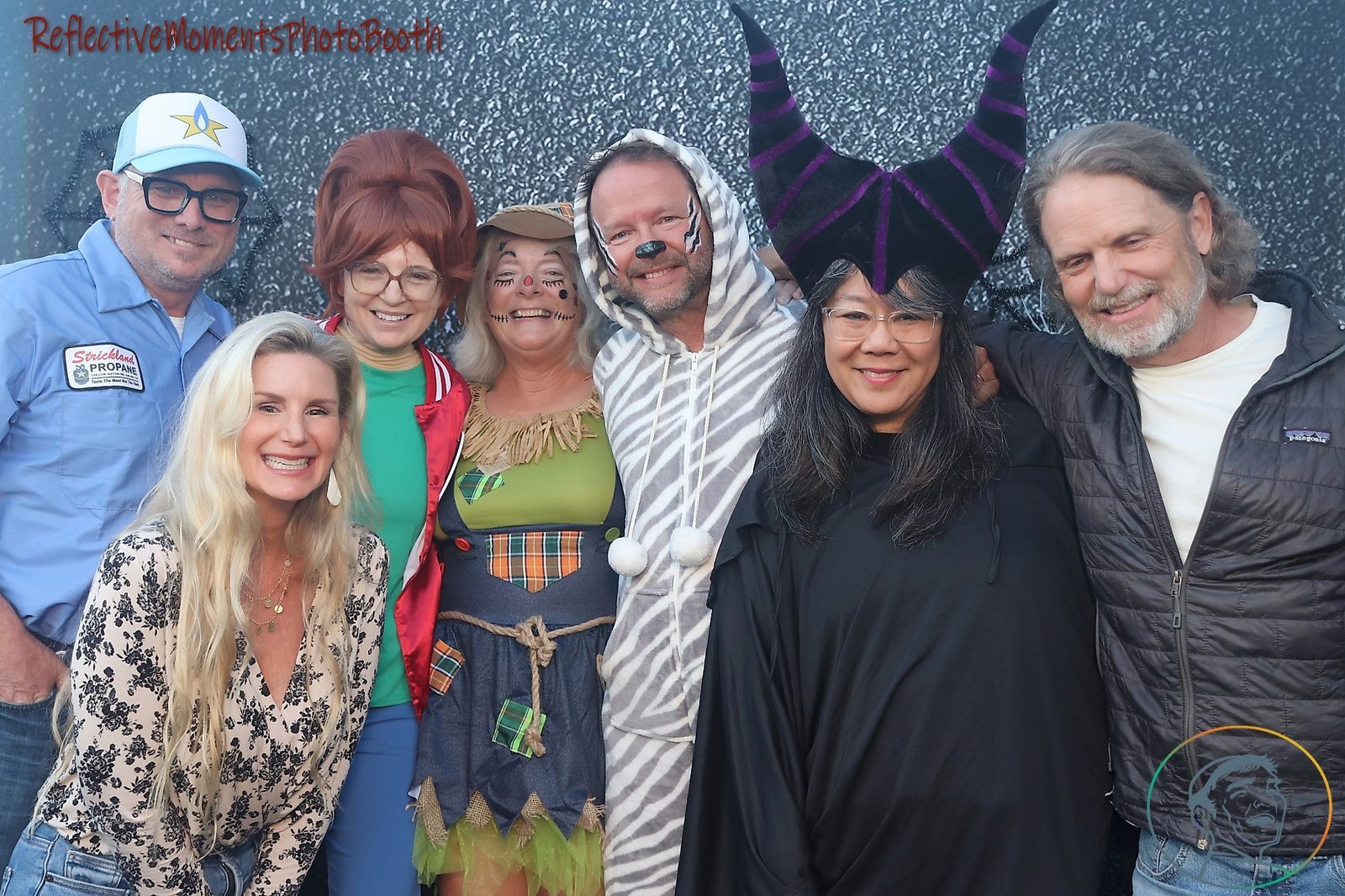 Halloween party guests laughing at the mirror photo booth