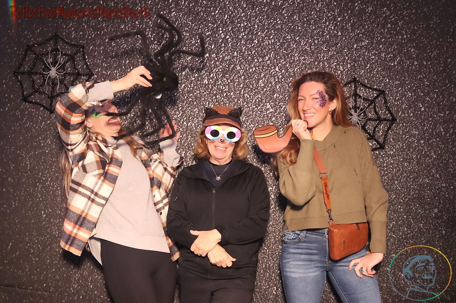 Halloween party guests striking a pose at the mirror booth