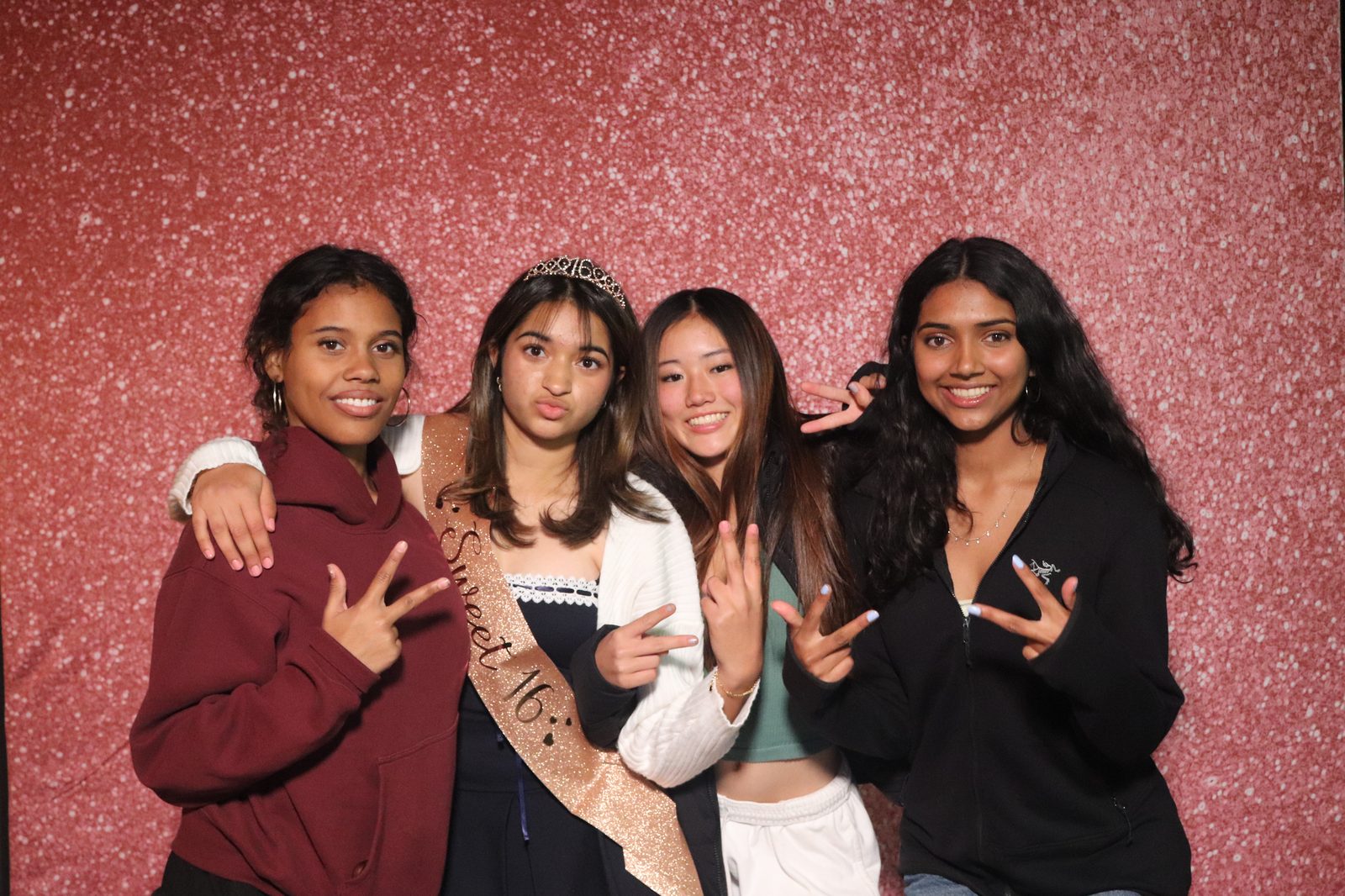 Guests posing at the Sweet 16 birthday party photo booth